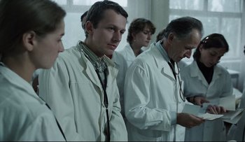 Movie still from “Blind Chance” (1987), directed by Krzysztof Kieslowski – A group of doctors standing next to each other in a room; Medium shot, Low angle