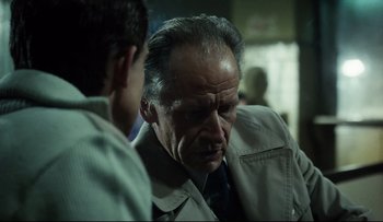 Movie still from “Blind Chance” (1987), directed by Krzysztof Kieslowski – A man in a tan jacket is talking to another man in a tan jacket; Close Up shot, Over the shoulder angle