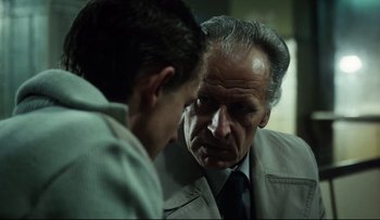 Movie still from “Blind Chance” (1987), directed by Krzysztof Kieslowski – A man in a suit talking to another man in a suit; Close Up shot, Over the shoulder angle