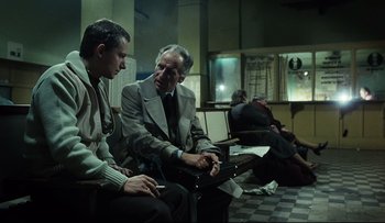Movie still from “Blind Chance” (1987), directed by Krzysztof Kieslowski – Two men are sitting in a waiting room; Medium shot, Over the shoulder angle