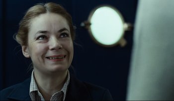 Movie still from “Blind Chance” (1987), directed by Krzysztof Kieslowski – A person smiling; Close Up shot, Over the shoulder angle