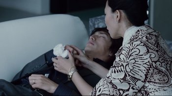 Movie still from “Blindness” (2008), directed by Fernando Meirelles – A man and a woman laying on a couch; Medium shot, High angle