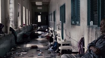 Movie still from “Blindness” (2008), directed by Fernando Meirelles – An abandoned room with a lot of trash on the floor; Wide shot, High angle
