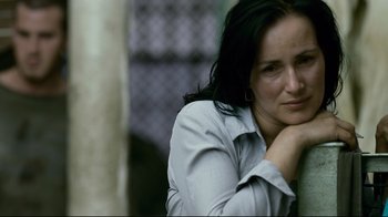 Movie still from “Blindness” (2008), directed by Fernando Meirelles – A person sitting on a bench; Close Up shot, High angle