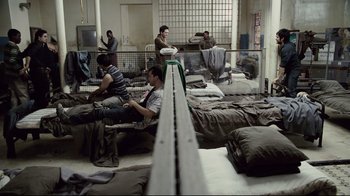 Movie still from “Blindness” (2008), directed by Fernando Meirelles – A group of people sitting on top of a bed; Wide shot, High angle