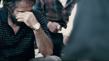 Movie still from “Blindness” (2008), directed by Fernando Meirelles – A man sitting in front of a group of other people; Close Up shot, Over the shoulder angle