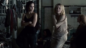 Movie still from “Blindness” (2008), directed by Fernando Meirelles – Two women standing next to each other in a room; Medium shot, Over the shoulder angle