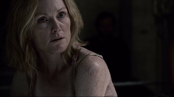 Movie still from “Blindness” (2008), directed by Fernando Meirelles – A person sitting in a room; Close Up shot, Over the shoulder angle