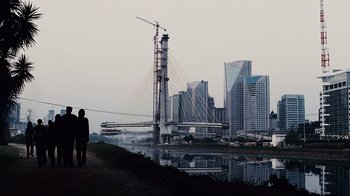 Movie still from “Blindness” (2008), directed by Fernando Meirelles – Two people are standing on a path near a bridge; Extreme Wide shot, Low angle