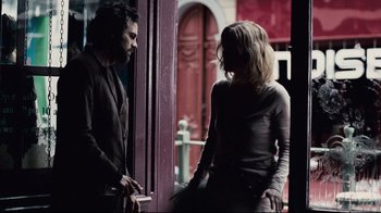 Movie still from “Blindness” (2008), directed by Fernando Meirelles – A man and a woman standing in front of a door; Medium shot, Over the shoulder angle