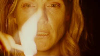 Movie still from “Blindness” (2008), directed by Fernando Meirelles – A woman's face with the sun shining on her face; Extreme Close Up shot, Overhead angle