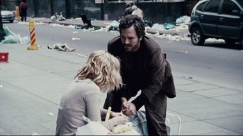 Movie still from “Blindness” (2008), directed by Fernando Meirelles – A man and a woman on the sidewalk; Medium shot, High angle