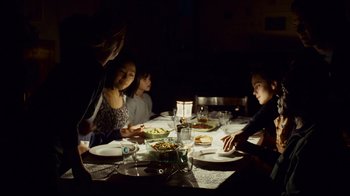 Movie still from “Blindness” (2008), directed by Fernando Meirelles – A group of people sitting at a dinner table; Medium shot, High angle