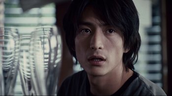 Movie still from “Blindness” (2008), directed by Fernando Meirelles – A person with long black hair; Close Up shot, Over the shoulder angle