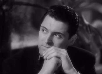 Movie still from “Blonde Venus” (1932), directed by Josef von Sternberg – A black - and - white photo of a man in a suit; Close Up shot, Low angle