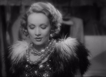 Movie still from “Blonde Venus” (1932), directed by Josef von Sternberg – An old photo of a woman in a dress with feathers; Close Up shot, Low angle