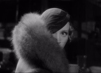 Movie still from “Blonde Venus” (1932), directed by Josef von Sternberg – A woman wearing a hat and a fur coat; Close Up shot, Over the shoulder angle