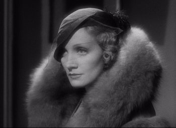 Movie still from “Blonde Venus” (1932), directed by Josef von Sternberg – An old photo of a woman wearing a hat and fur; Close Up shot, Low angle