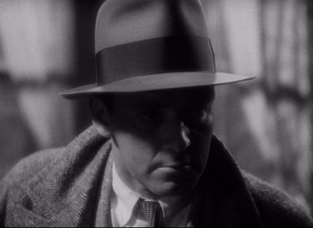 Movie still from “Blonde Venus” (1932), directed by Josef von Sternberg – A black and white photo of a man wearing a hat; Close Up shot, Low angle