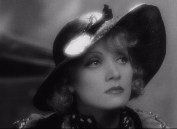 Movie still from “Blonde Venus” (1932), directed by Josef von Sternberg – An old photo of a woman wearing a hat; Close Up shot, Low angle