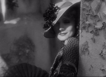 Movie still from “Blonde Venus” (1932), directed by Josef von Sternberg – A black and white photo of a woman with a hat; Close Up shot, High angle