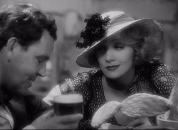 Movie still from “Blonde Venus” (1932), directed by Josef von Sternberg – A man and a woman holding a glass of beer; Close Up shot, Over the shoulder angle