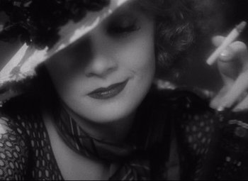 Movie still from “Blonde Venus” (1932), directed by Josef von Sternberg – A black and white photo of a woman wearing a hat; Extreme Close Up shot, High angle