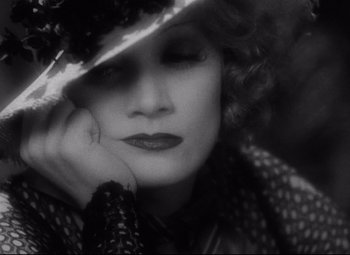 Movie still from “Blonde Venus” (1932), directed by Josef von Sternberg – A black and white photo of a woman wearing a hat; Close Up shot, High angle
