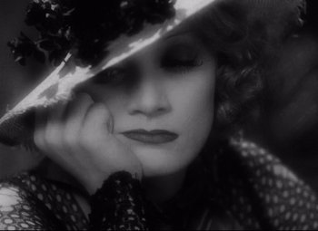 Movie still from “Blonde Venus” (1932), directed by Josef von Sternberg – A black - and - white photo of a woman in a hat; Extreme Close Up shot, High angle