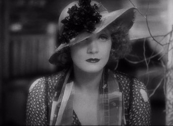 Movie still from “Blonde Venus” (1932), directed by Josef von Sternberg – An old photo of a woman wearing a hat; Close Up shot, High angle