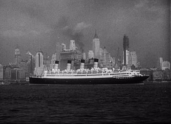 Movie still from “Blonde Venus” (1932), directed by Josef von Sternberg – A black and white photo of a large ship in the water; Extreme Wide shot, High angle