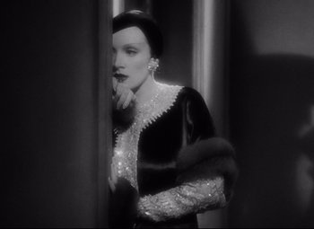 Movie still from “Blonde Venus” (1932), directed by Josef von Sternberg – A black and white photo of a woman looking in a mirror; Close Up shot, Low angle