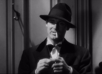 Movie still from “Blonde Venus” (1932), directed by Josef von Sternberg – A black and white photo of a man smoking a cigarette; Close Up shot, Over the shoulder angle