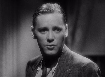 Movie still from “Blonde Venus” (1932), directed by Josef von Sternberg – An old photo of a man in a suit; Close Up shot, Low angle