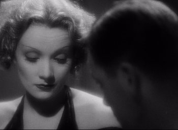 Movie still from “Blonde Venus” (1932), directed by Josef von Sternberg – A man and a woman face to face in a black and white photo; Close Up shot, High angle