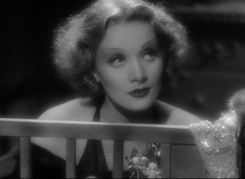 Movie still from “Blonde Venus” (1932), directed by Josef von Sternberg – An old photo of a woman sitting in a chair; Close Up shot, Low angle
