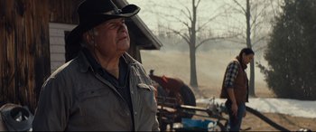 Movie still from “Blood Quantum” (2019), directed by Jeff Barnaby – An older man wearing a cowboy hat looking off into the distance; Medium shot, Low angle