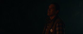 Movie still from “Blood Quantum” (2019), directed by Jeff Barnaby – A man standing in the dark looking up at the sky; Close Up shot, Over the shoulder angle