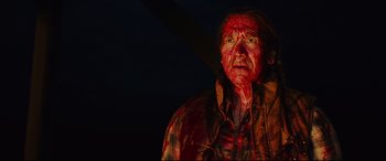 Movie still from “Blood Quantum” (2019), directed by Jeff Barnaby – A man with blood all over his face and chest; Medium shot, High angle
