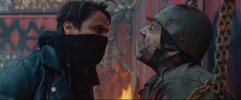 Movie still from “Blood Quantum” (2019), directed by Jeff Barnaby – A man and a woman face to face in front of a burning building; Close Up shot, Over the shoulder angle