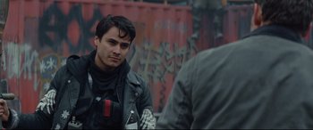 Movie still from “Blood Quantum” (2019), directed by Jeff Barnaby – A man in a black leather jacket looking at another man in a black leather jacket; Close Up shot, Over the shoulder angle