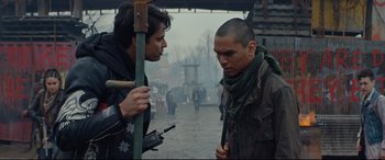 Movie still from “Blood Quantum” (2019), directed by Jeff Barnaby – Two men standing next to each other on the street; Medium shot, Over the shoulder angle