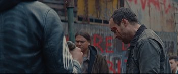 Movie still from “Blood Quantum” (2019), directed by Jeff Barnaby – A man with a face paint is looking at another man with paint on his face; Medium shot, Over the shoulder angle