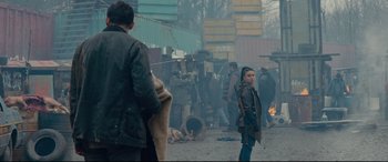 Movie still from “Blood Quantum” (2019), directed by Jeff Barnaby – A group of people standing on a street; Wide shot, Over the shoulder angle