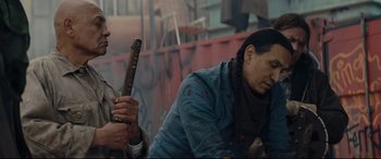 Movie still from “Blood Quantum” (2019), directed by Jeff Barnaby – A man holding a wooden sword in his hand; Medium shot, Over the shoulder angle