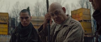 Movie still from “Blood Quantum” (2019), directed by Jeff Barnaby – An older man holding a stick in front of him; Close Up shot, Over the shoulder angle