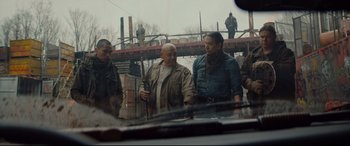 Movie still from “Blood Quantum” (2019), directed by Jeff Barnaby – A group of men standing next to each other on a bridge; Medium shot, Over the shoulder angle
