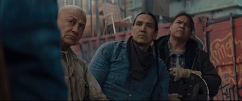 Movie still from “Blood Quantum” (2019), directed by Jeff Barnaby – A group of men standing next to each other; Medium shot, Over the shoulder angle