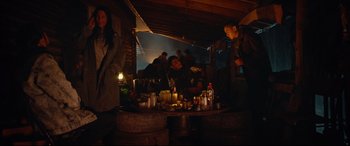 Movie still from “Blood Quantum” (2019), directed by Jeff Barnaby – A group of people standing around a table with lit candles; Wide shot, Over the shoulder angle