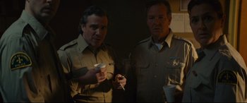 Movie still from “Blood Quantum” (2019), directed by Jeff Barnaby – A couple of men standing next to each other holding drinks; Medium shot, Low angle